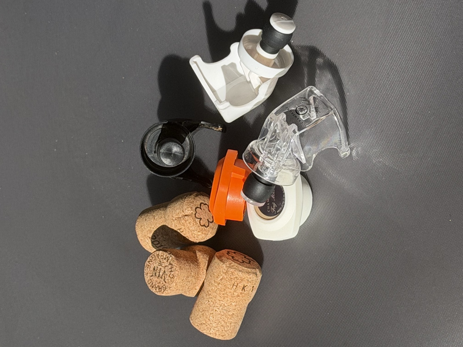 Natural champagne corks next to several reusable cork stoppers
